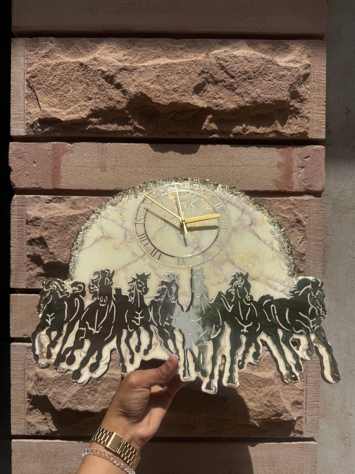 Handcrafted marble effect wall clock with Roman numerals, gold hands and running horse silhouette